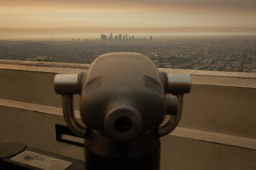 looking through binoculars at city