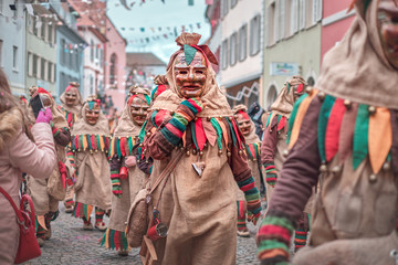 Group of friendly carnival figures at a street party. Carnival in southern Germany - Black Forest