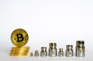 Bitcoin with and weights engraved with symbols of dollar, showing the growth and decline.