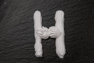 The letters of the English alphabet written in white cream