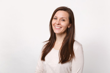 Obraz premium Portrait of smiling beautiful cute young woman in light clothes standing and looking camera isolated on white wall background in studio. People sincere emotions lifestyle concept. Mock up copy space.