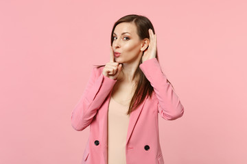 Cute young woman saying hush be quiet with finger on lips shhh gesture eavesdrop with hearing...