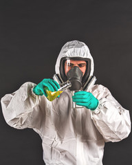 male researcher analyzing liquid reagent in laboratory glassware