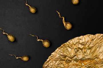 Fertilization golden foil sperm cells isolated on black background