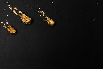Golden comet ball of foil isolated on black background