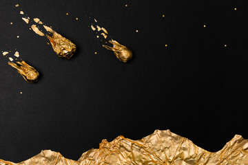 Golden comet ball of foil isolated on black background