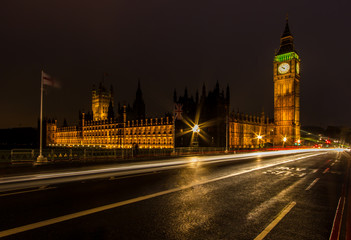 Fototapeta na wymiar A night long exposure of the House of Parliament and Big Ben along the Westminster Bridge with traffic light trails