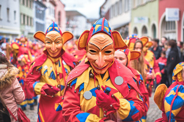 Carnival figure with big ears in yellow, blue costume. Carnival in southern Germany - Black Forest