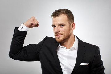 Businessman flexing biceps