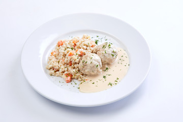 meatballs with barley on the white plate