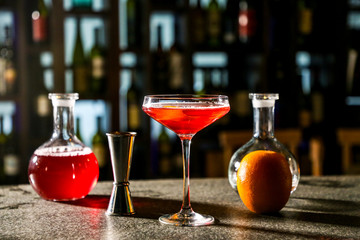 The Cocktail Is Cosmopolitan. Bartender preparing a cocktail.
