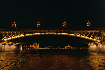 Fototapeta na wymiar Illuminated bridge with street lantern on the Danube River. A pa