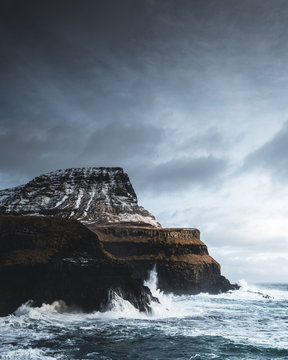 Waves break on the cliffs of the Westfjords, Iceland