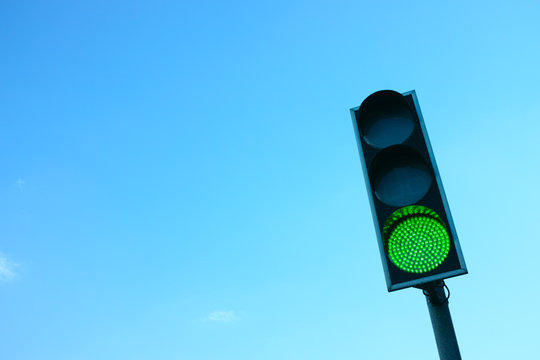 Green Traffic Light Against the Sky