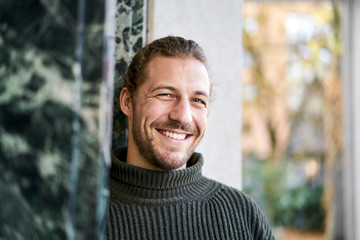 Portrait of bearded young man laughing