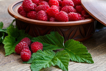 Fresh ripe raspberries on the wooden table