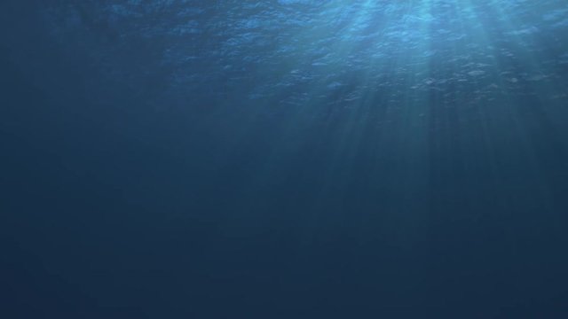 Seamless loop of a tranquil underwater scene with ocean waves and sun and light rays shining through - high quality 3d animation