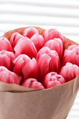 Bouquet of pink fresh tulips. Greeting card. Modern photo.