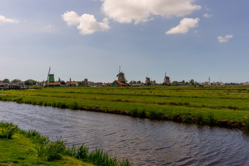 Netherlands, Zaanse Schans, windmills on a meadow with a canal