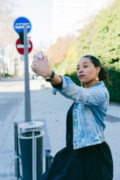 Woman taking a selfie in the street