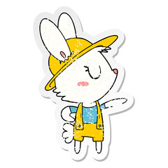 distressed sticker of a cartoon rabbit construction worker