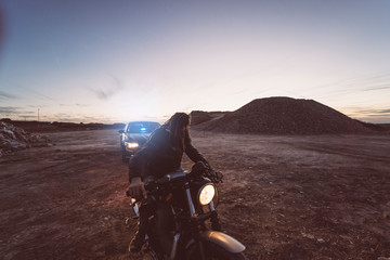 Spain, Madrid, Man with motorcycle and dreadlocks mocks policeman