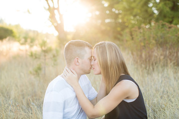 Beautiful young couple kissing in sunny field