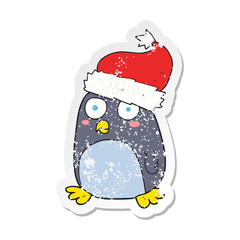 retro distressed sticker of a cartoon penguin in christmas hat