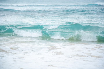 Close up of waves crashing onto the beaches. 