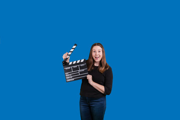 Beautiful young women using a clipperboard excited expression on her face bright solid blue background 