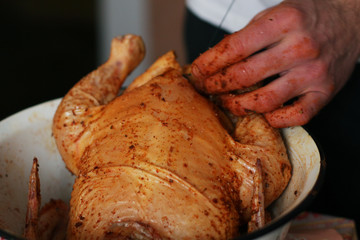 The young guy is cooking big chicken