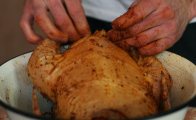 The young guy is cooking big chicken