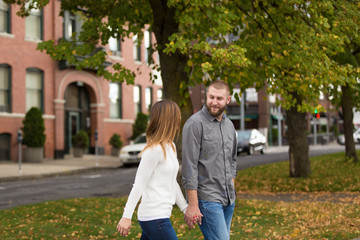 young attractive couple walking and holding hands