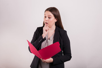 Young business professional woman with folder reading interesting look 