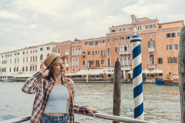 Fototapeta na wymiar Woman in the Venice, standing on the pier on the grand canal. Discovering Venice Italy.