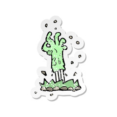 retro distressed sticker of a cartoon zombie hand rising from ground