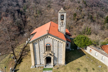 Fototapeta premium Aerial view of Sant Ambrogio Church situated in painted village Arcumeggia in province of Varese, Italy