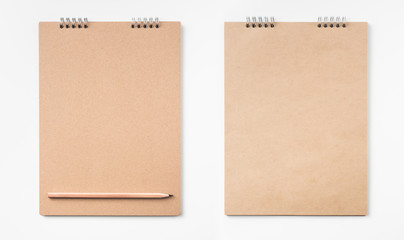 kraft notebook and pen on white background