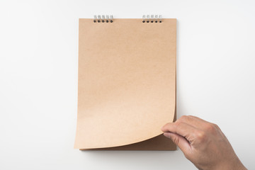 man's hand turn up kraft page on white