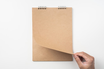 man's hand turn up kraft page on white