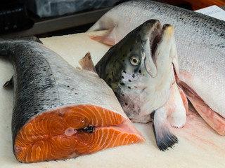 a salmon cut into pieces offered on a fish market