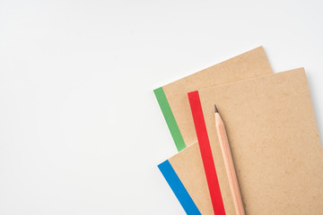 3 kraft notebook and pen on white background