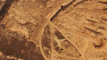 View of the large red truck in desert moving on a sandy track. Desert trip.