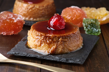 homemade egg custard with caramelized fruits on black stone tray