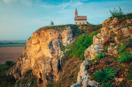 Old Drazovce church at dawn, man standing next to church