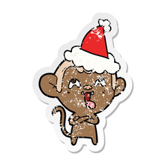 crazy distressed sticker cartoon of a monkey wearing santa hat