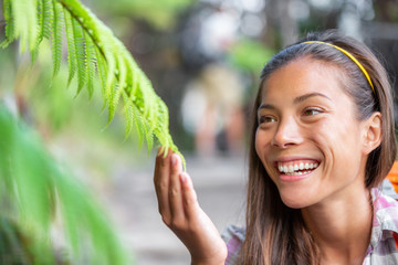 Nature interpretation park guide woman touching plants for environment class about wilderness in...