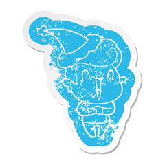 excited man cartoon distressed sticker of a wearing santa hat