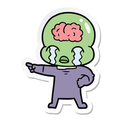 sticker of a cartoon big brain alien crying and pointing