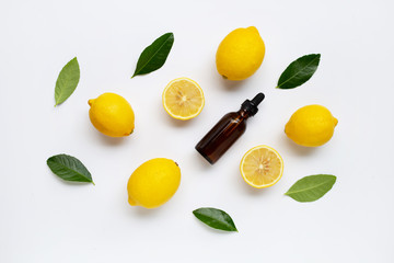 Fresh lemon with lemon essential oil on white background.